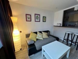 a living room with a couch and a table at Przy Stawikach in Sosnowiec