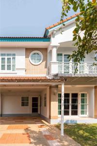 a large white house with a balcony at Top family house in peaceful area with lake view 3BR 15 mins to city in Chiang Mai