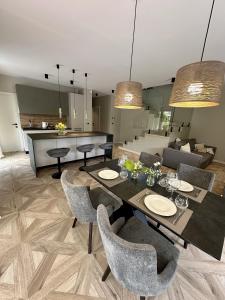 a dining room with a table and chairs and a kitchen at Villa Perla in Mošćenička Draga