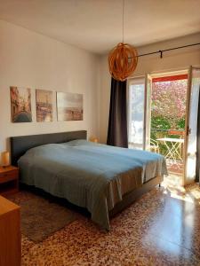 a bedroom with a bed and a large window at Villa dei Pini in Laveno-Mombello
