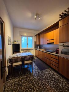 a kitchen with a table in the middle of it at Villa dei Pini in Laveno-Mombello +26 photos