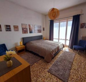 a bedroom with a bed and a large window at Villa dei Pini in Laveno-Mombello