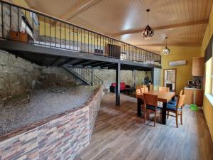 a kitchen and dining room with a staircase and a table at Moinhos da Pereira - Turismo Rural in Tarouca