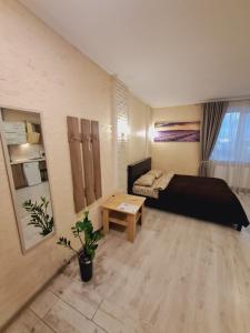 a room with a bed and a table in it at New modern apartments in the center in Ivano-Frankivsʼk