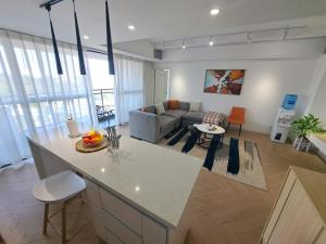 a kitchen and living room with a couch and a table at Modern 1BR Apartment in Upperhill, Nairobi in Nairobi