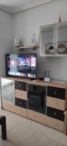 a large entertainment center with a flat screen tv at Apartamento Giovanni - Marina D'Or in El Borseral