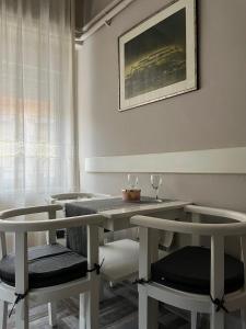 a dining room with a table and two chairs at Alma - Panonia Apartments in Novi Sad