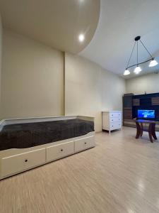 a large room with a bed and a tv at OLD TOWN Republika - 2 rooms - Self Check In - 24 hours - Free parking in Liepāja