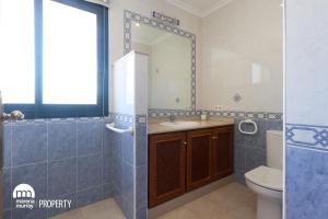a bathroom with a sink and a toilet and a mirror at La Manga Club Hacienda Del Golf in Atamaría +11 photos