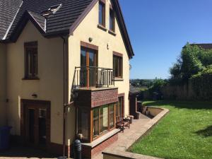 a house with a balcony on the side of it at Parkwood House in Dungannon