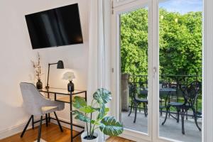 un soggiorno con porta scorrevole in vetro, tavolo e sedie di Spacious & Tranquil Rooms in Limpertsberg a Lussemburgo