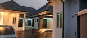 a row of houses with a car parked next to them at Daprem Self-Contain Service Apartments in Uyo