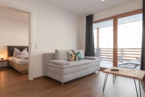 una sala de estar con un sofá y una cama en Sonnseit 21, en Grossarl 32 fotos más