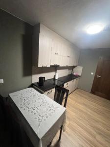 a small kitchen with a bed and a table at Bestdrive Pokój 4 in Babienica +1 photo