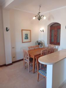 a dining room with a wooden table and chairs at Rihana 2 bedrooms in Hurghada