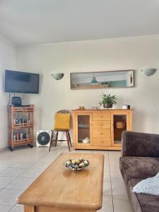 a living room with a bowl of fruit on a coffee table at Bayview Apartment 106 in Albufeira +15 photos