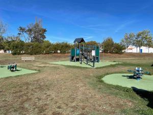 a park with a playground with a swing at Maisonnette Le Galet Jaune in Bretignolles-sur-Mer