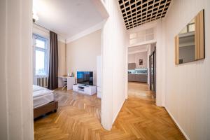 a room with a bed and a television in it at Budapest Grand Danube Suite in Budapest