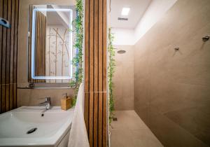 a bathroom with a sink and a shower at Budapest Grand Danube Suite in Budapest