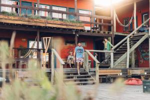 a man walking up the stairs of a building at Compay Hostel Punta del Diablo in Punta Del Diablo
