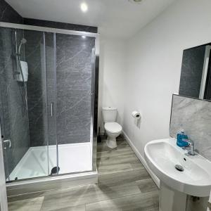 a bathroom with a shower and a toilet and a sink at City Centre House in Southampton