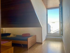 a bedroom with a blue bed and a window at Uno Due Tre Stella in Chioggia