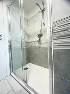 a shower with a glass door in a bathroom at Uno Due Tre Stella in Chioggia +21 photos