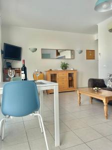 a living room with a table and a blue chair at Bayview Apartment 106 in Albufeira