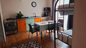 a kitchen with a table and chairs in a room at Sonvanger Gastehuis in Bethlehem