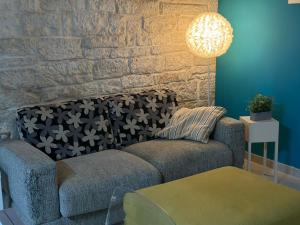 a living room with a couch and a brick wall at Nel cuore di Giovinazzo in Giovinazzo +39 photos