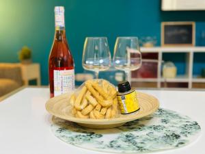 a plate of french fries and a bottle of wine at Nel cuore di Giovinazzo in Giovinazzo