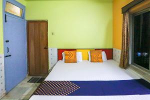 Voodi või voodid majutusasutuse Hotel O Bideshini Hotel toas