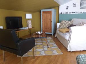 a living room with a couch and a table at clos st Joseph in Oullins
