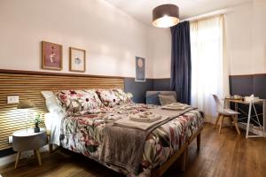 a bedroom with a bed and a table and a desk at Savi Guest House metro B S Paolo in Rome