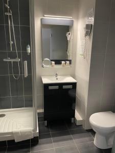a bathroom with a sink and a shower and a toilet at Cit'Hotel Le Chêne Vert in Les Sables-dʼOlonne +33 photos