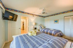a bedroom with two beds and a flat screen tv at Oceanfront Marco Island Escape with Beach Access! in Marco Island +18 photos