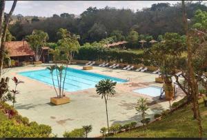 a large swimming pool with lounge chairs around it at Chale ITU- Camping Carrion -Tomorrowland 2 in Itu