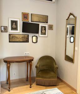 a room with a table and a chair and a mirror at Irin Hotel in Antibes