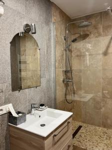 a bathroom with a sink and a shower at Irin Hotel in Antibes +15 photos