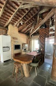 a kitchen with a wooden table in a room at Casa de campo in Itapema