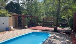 a swimming pool in a backyard with a gazebo at Casa de campo in Itapema