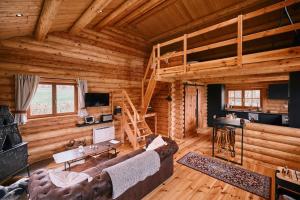 a living room of a log cabin with a loft at Le chalet Nord in Verviers
