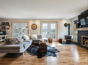 a living room with a couch and a fireplace at Yomi Chalet in Lac-Superieur