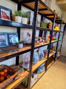 a store shelf filled with lots of food at Woodlonge Tinyhouse in Lathum
