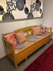a wooden bench with pillows on it in a room at Villan dubbelrum in Sundsvall