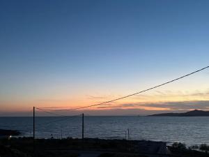 a view of the ocean at sunset at Eagle View Karystos in Karistos +5 photos
