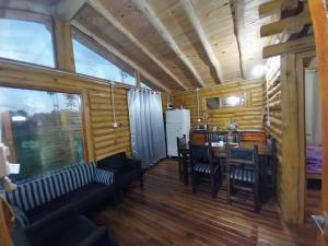 a living room with a table and a dining room at La Soñada in San Javier