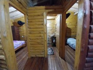 a log cabin with two beds in a room at La Soñada in San Javier