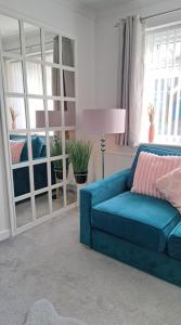 a blue couch sitting in a living room at Self Catering Appartment 1 bedroom 2 double beds in East Cowes