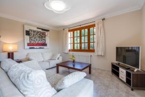 a living room with two white couches and a television at Apartment Sol 2 in Port de Soller